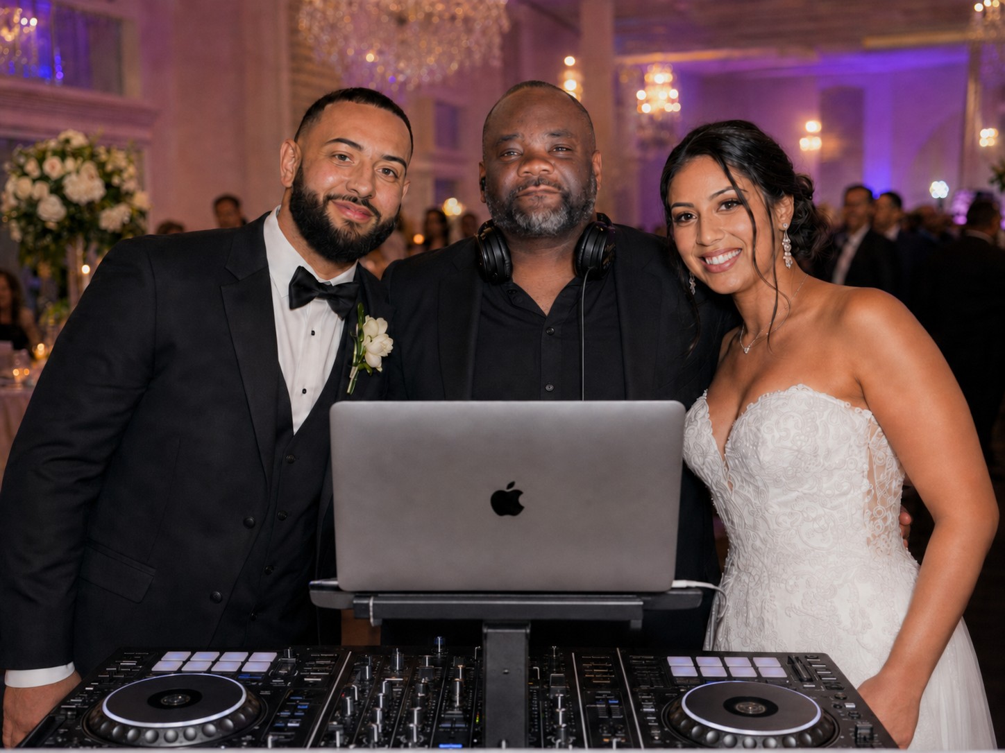 DJ Glenn celebrating with a newlywed couple at their wedding reception